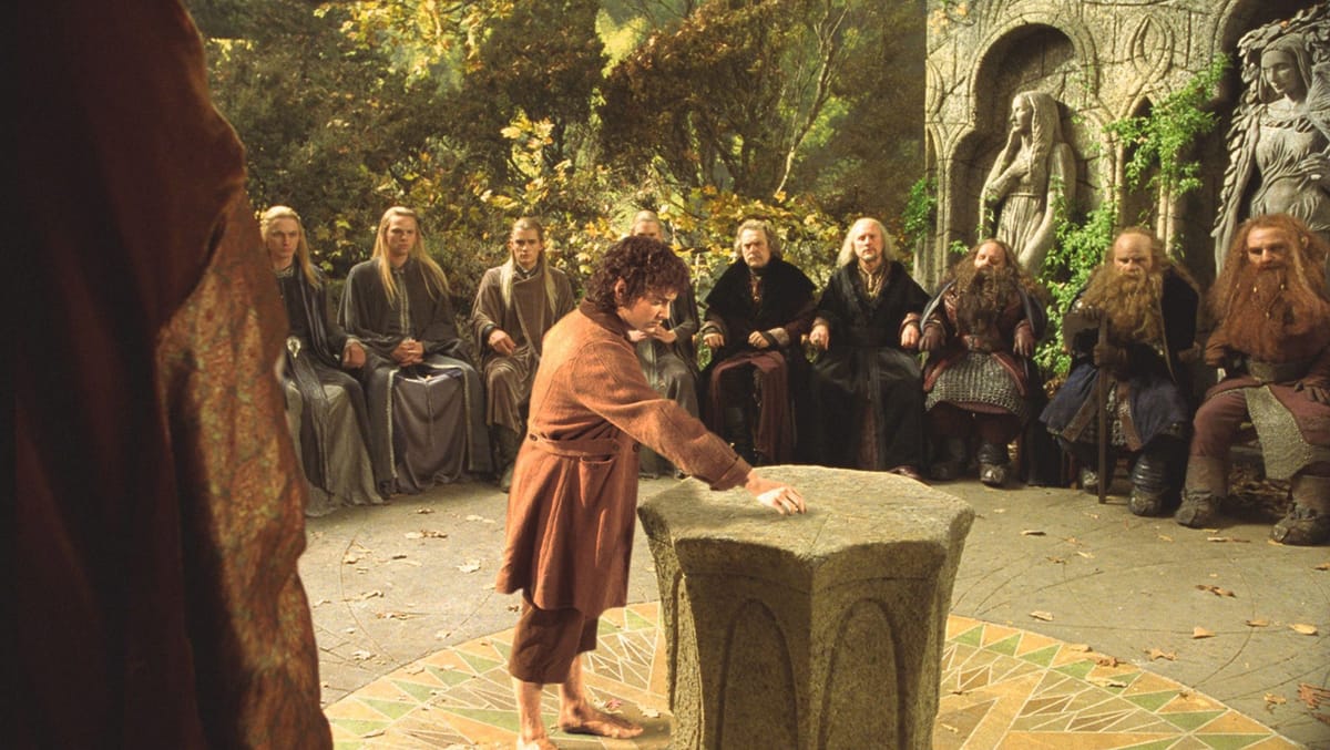 A picture of Elves, Humans, and Dwarves sitting at the Council of Elrond